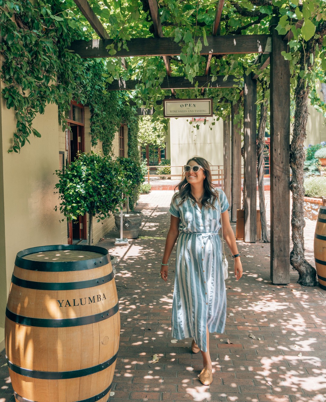 A girl wearing a dress walks into Yalumba winery in the Barossa Valley - a day trip from Adelaide
