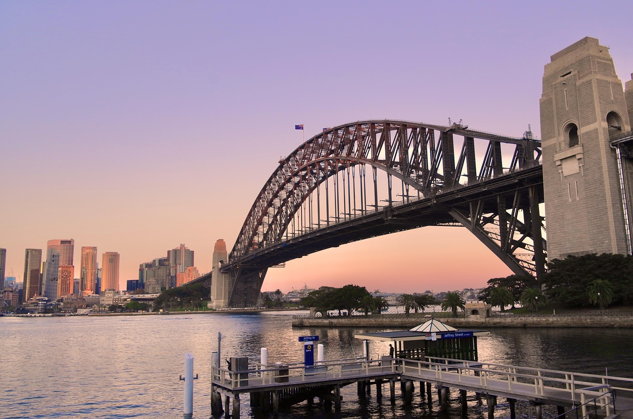 Views of the CBD and the sunset over the Sydney Harbour Bridge with the Australian flag on top