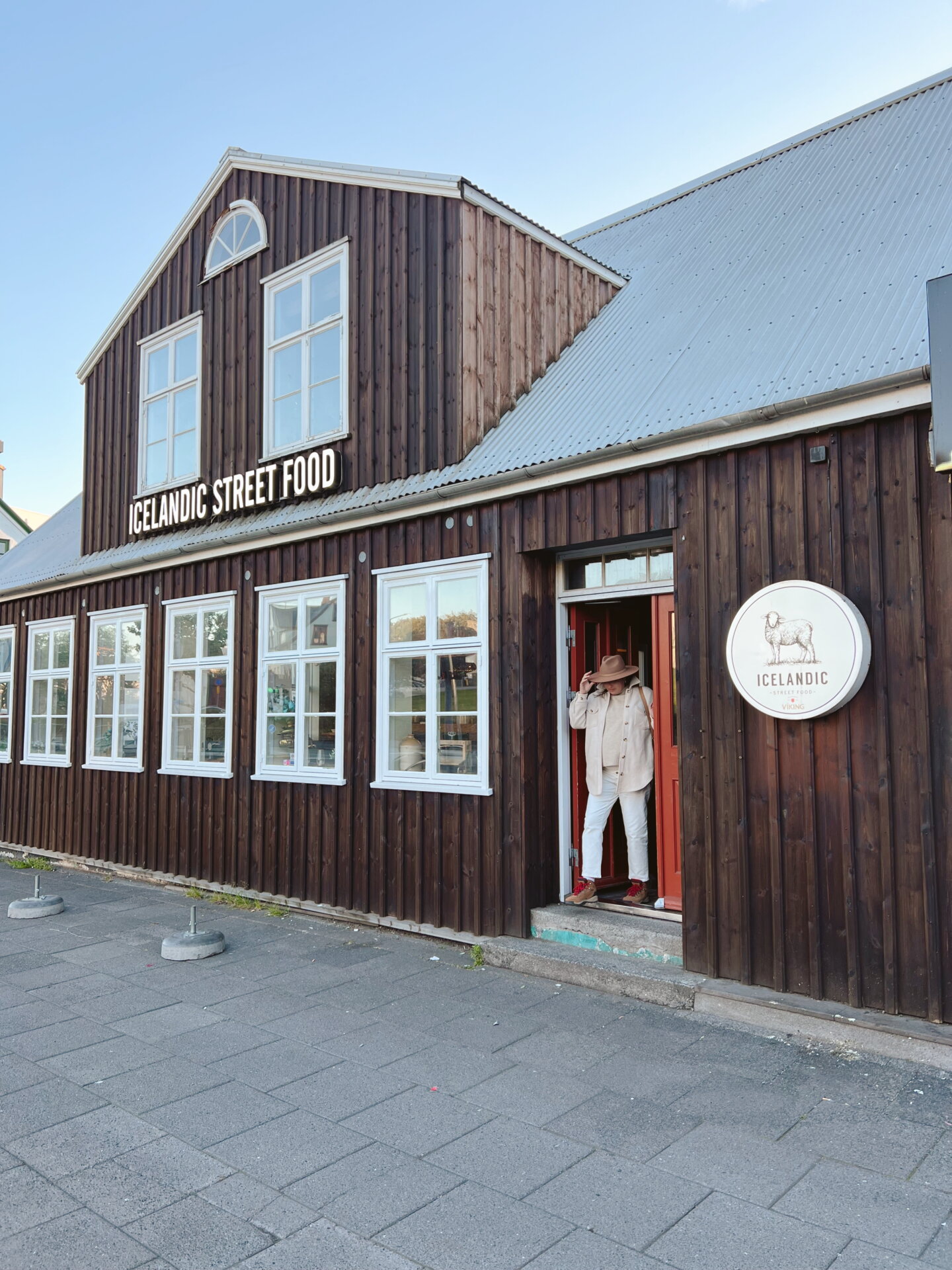 A women walks out of the Icelandic Street Food Restaurant in Reykjavik, Iceland