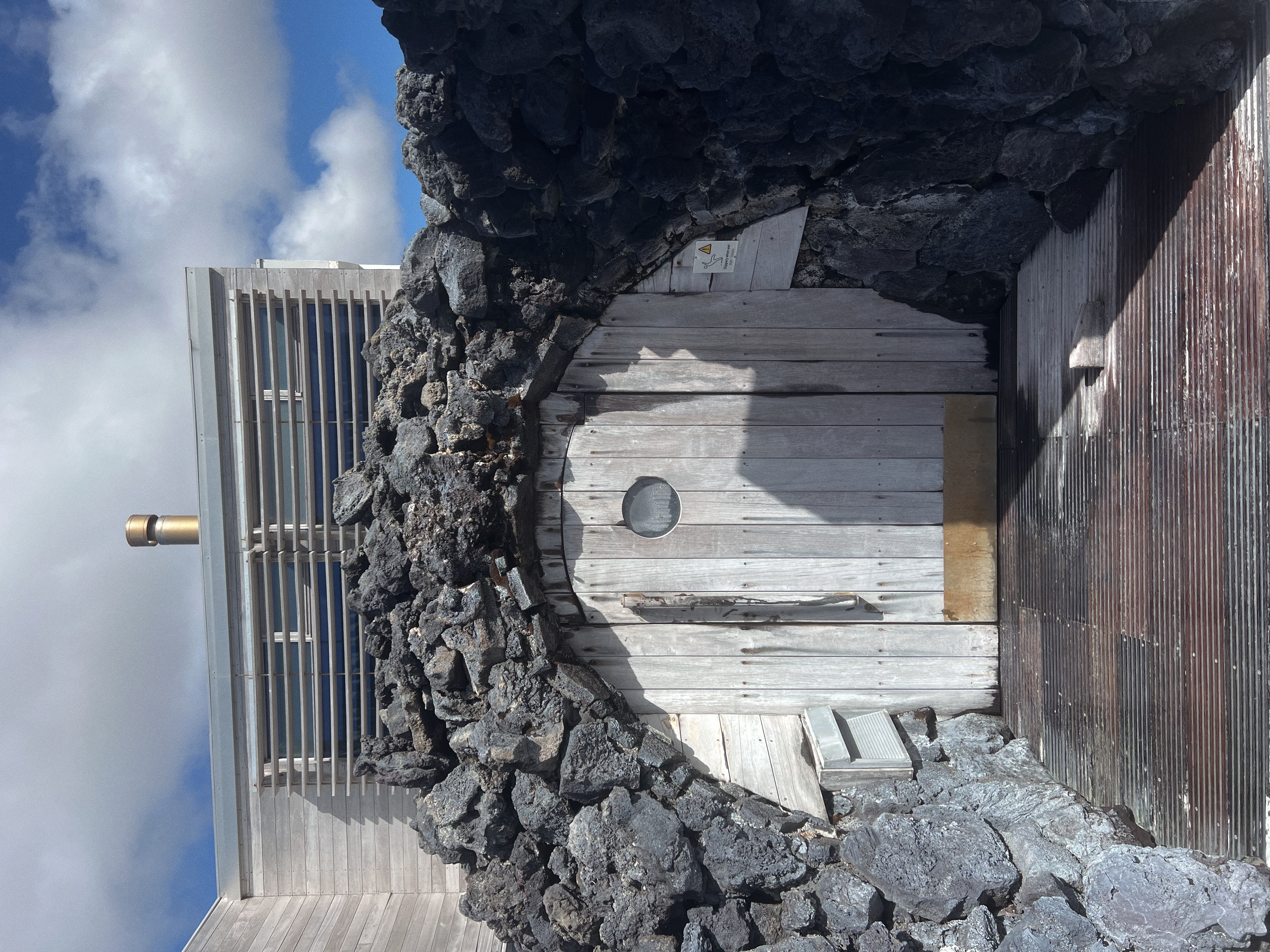 Blue Lagoon sauna surrounded by volcanic lava rocks and fields in Iceland