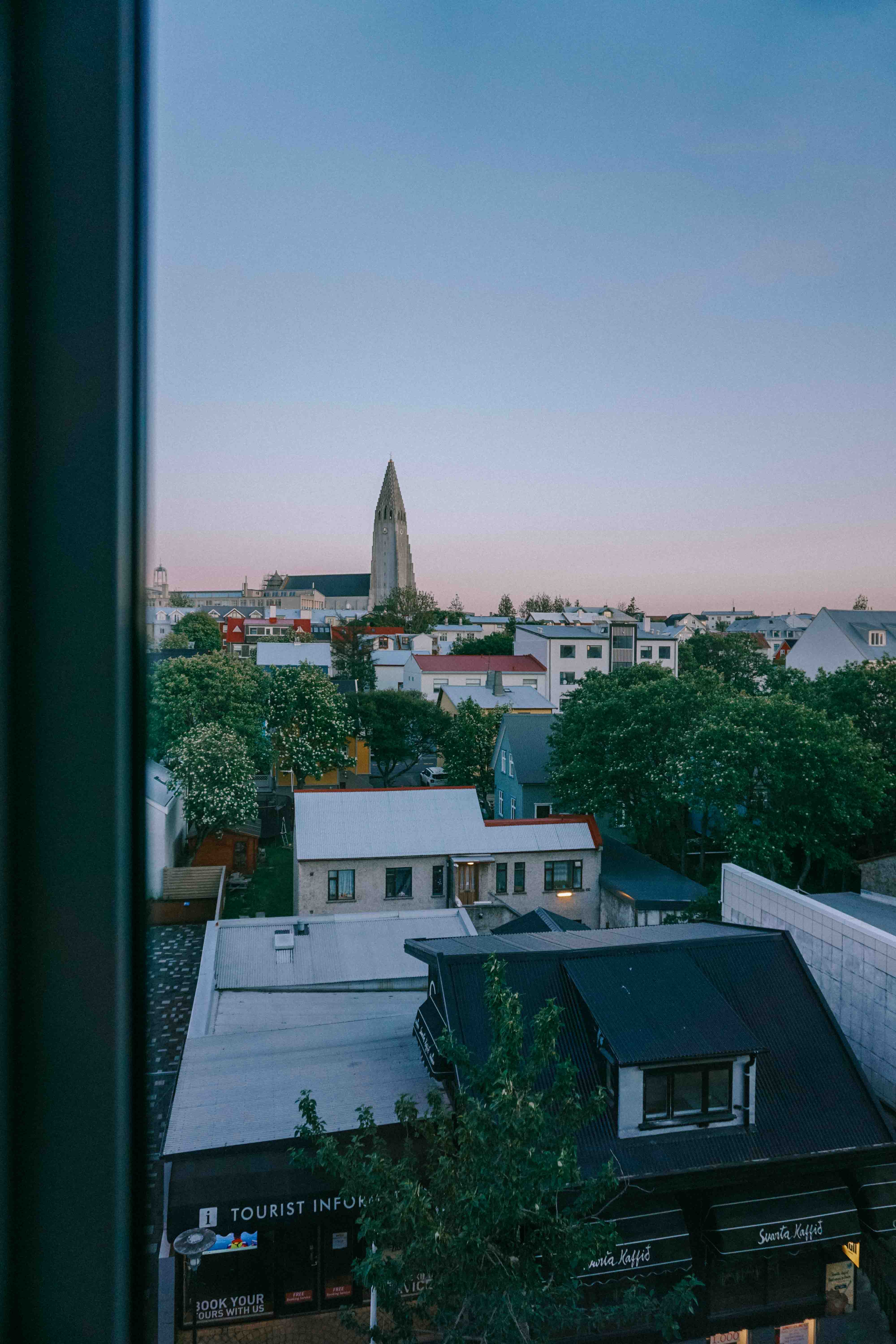 The midnight sun skies in Reykjavik during summer - the best time to go on a road trip in Iceland.