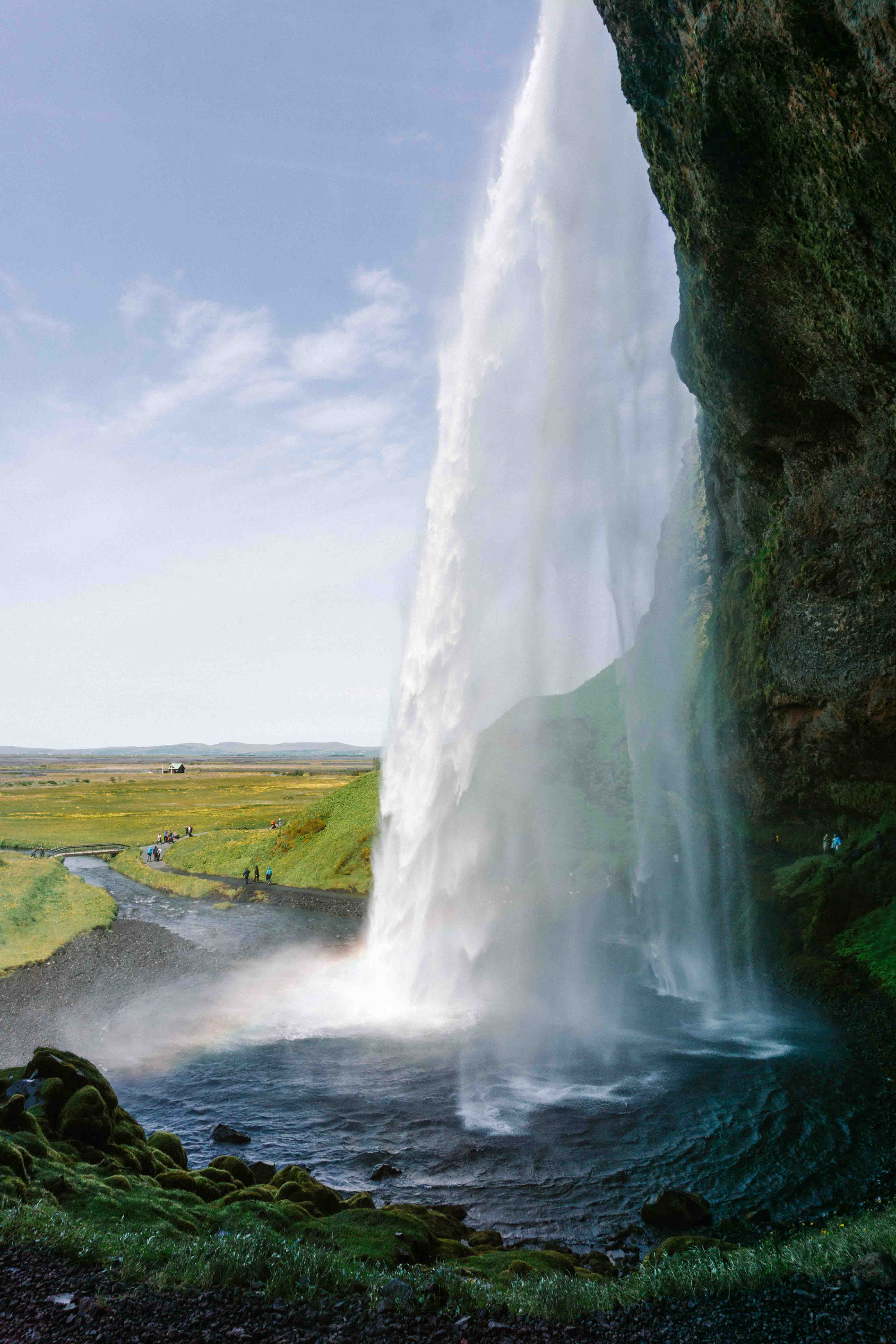The stunning view from behind Seljalandsfoss waterfall in Iceland