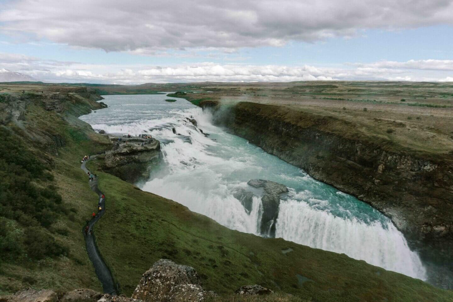 The view of Iceland’s iconic Gullfoss waterfall from the Golden Circle road trip in the summer time.