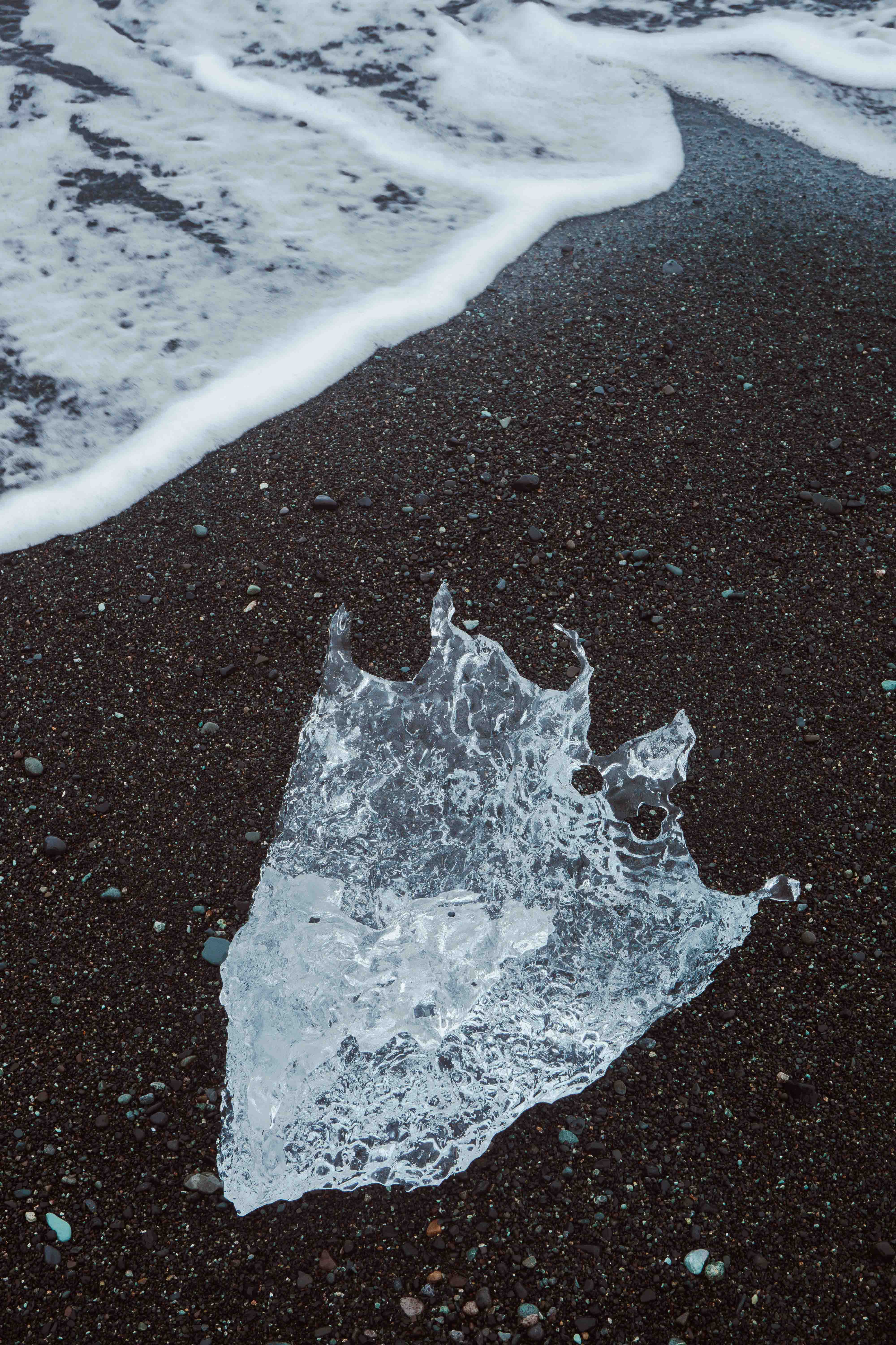 Diamond Beach with shimmering ice chunks on black sand, part of an Iceland road trip